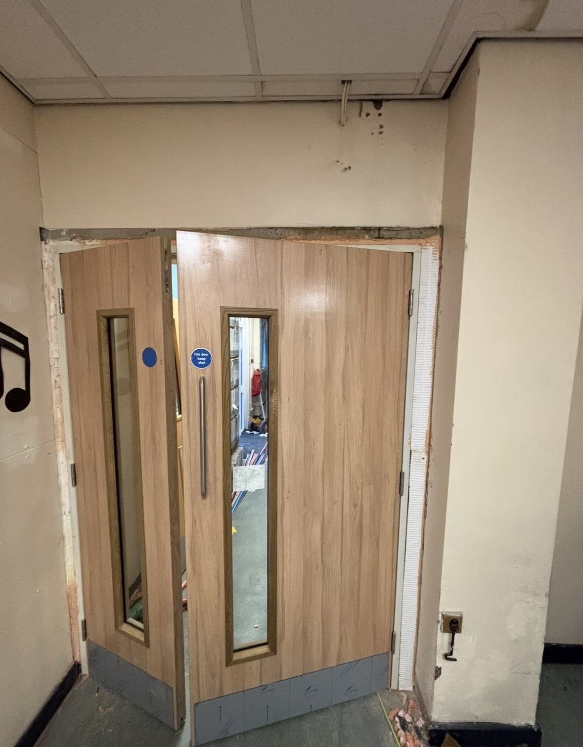 Fire door being installed by Eves Joinery